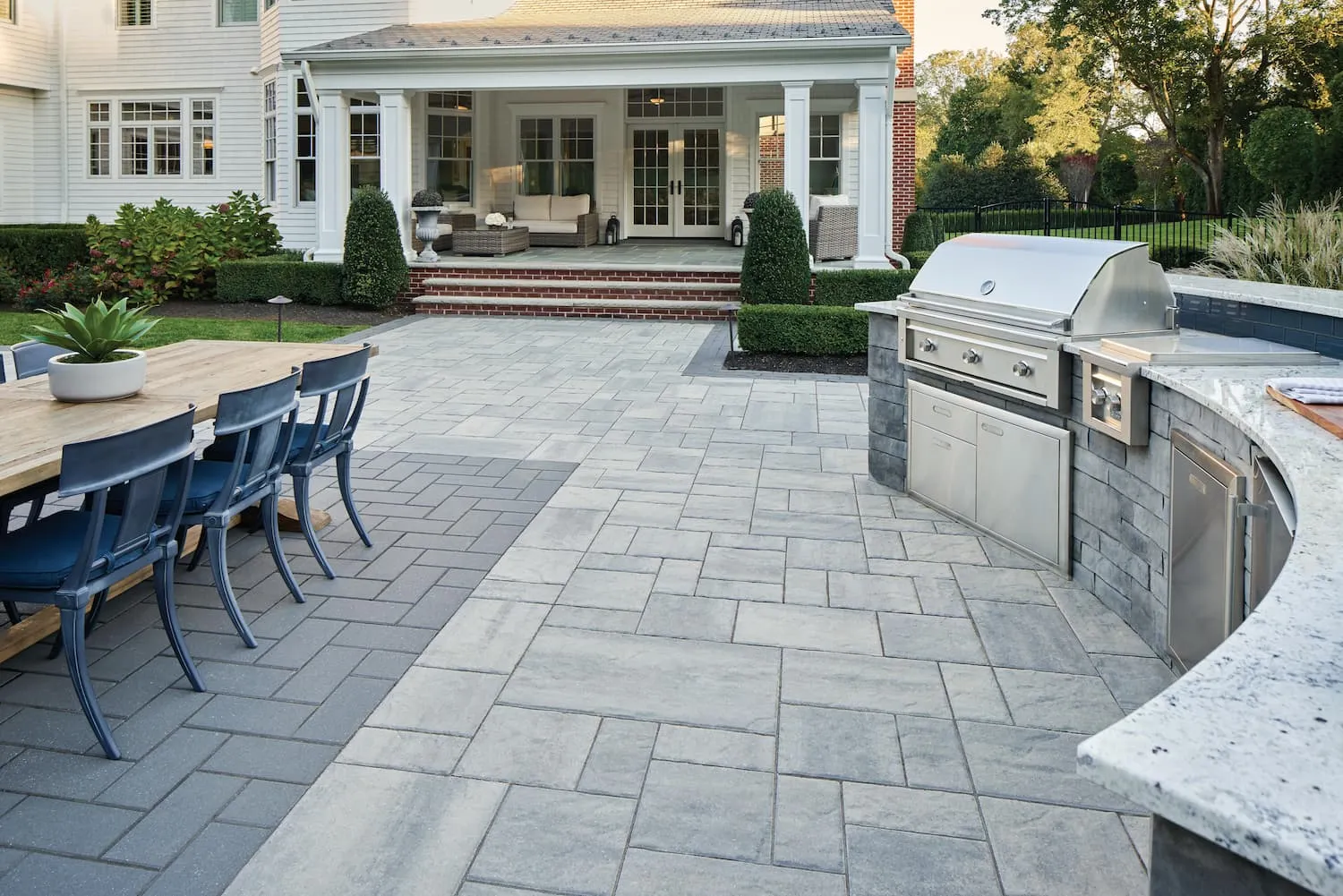 Paver patio with an outdoor kitchen and dining set
