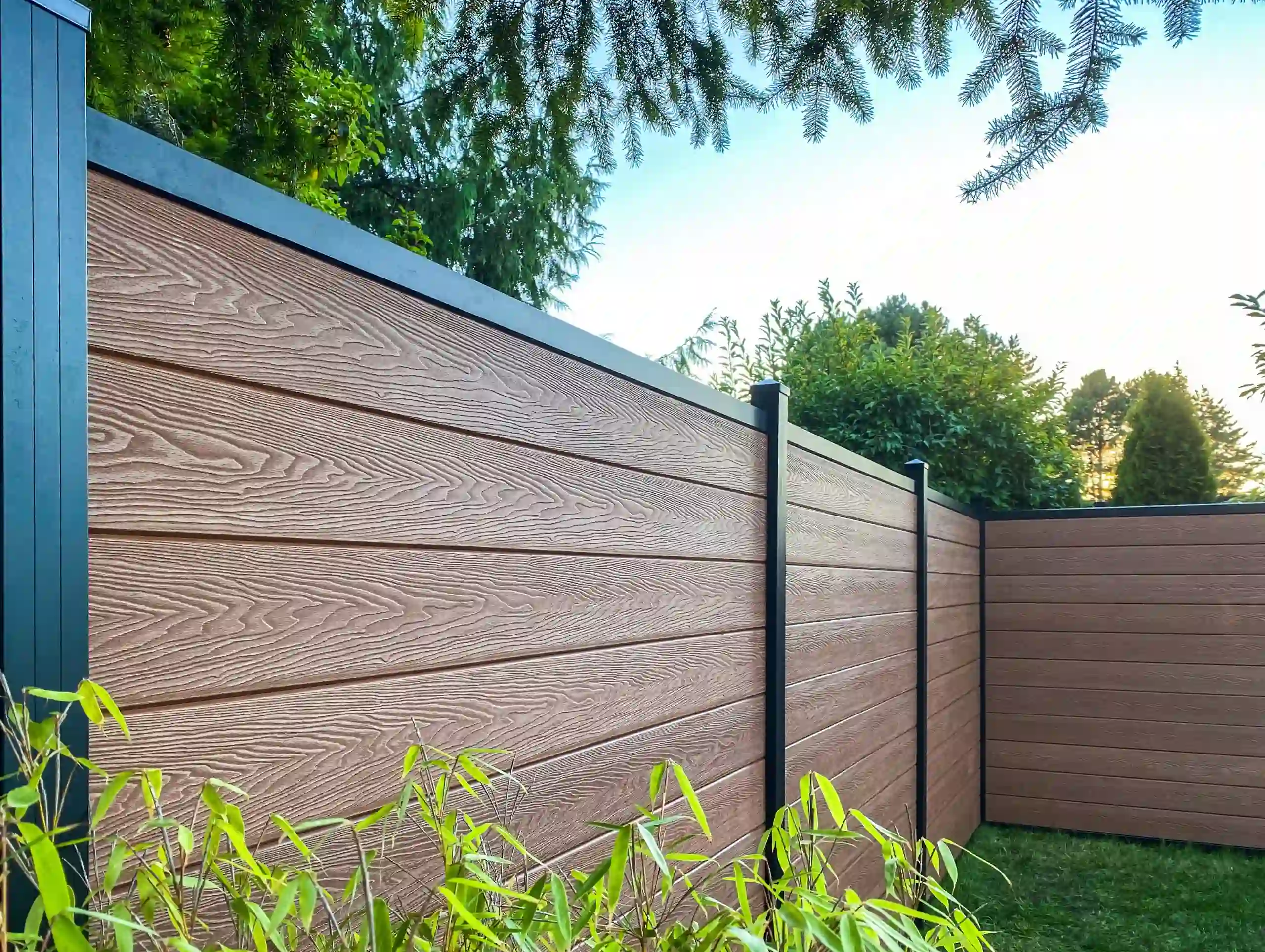 Brown composite privacy fence in a backyard