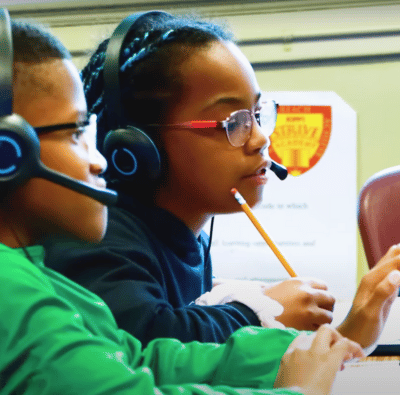 Boy and girl collaborate with OKO on computers
