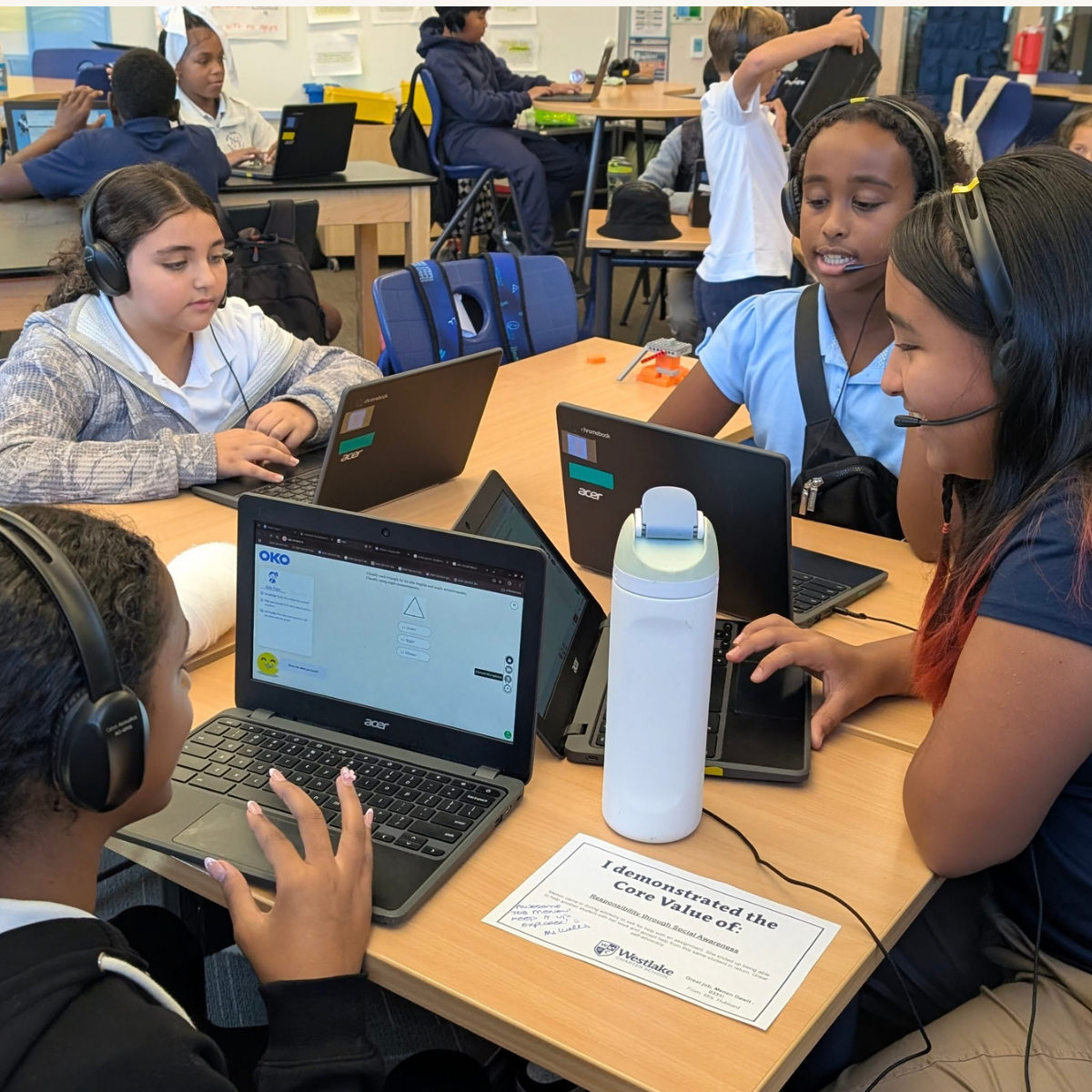 Students at Westlake Charter School gather around Chromebooks with the OKO interface during a small-group math activity