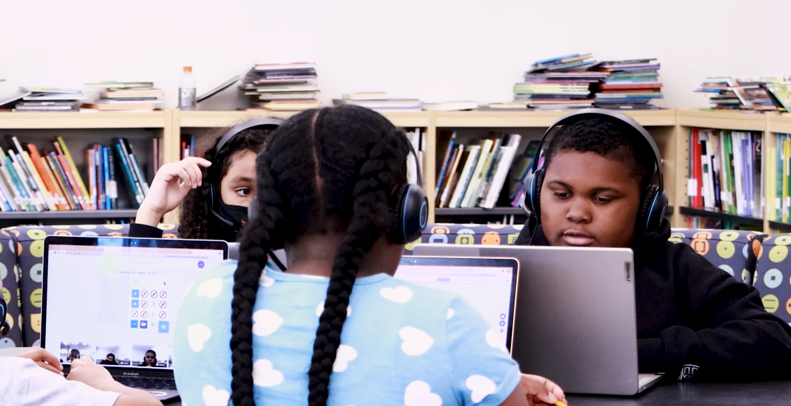 Students at Kindezi at Gideons Elementary use headsets and laptops to participate in an OKO math discussion