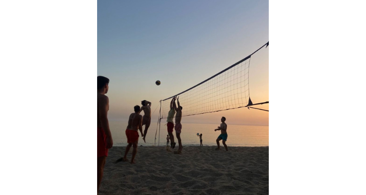 playing beach volleyball as a hobby with friends