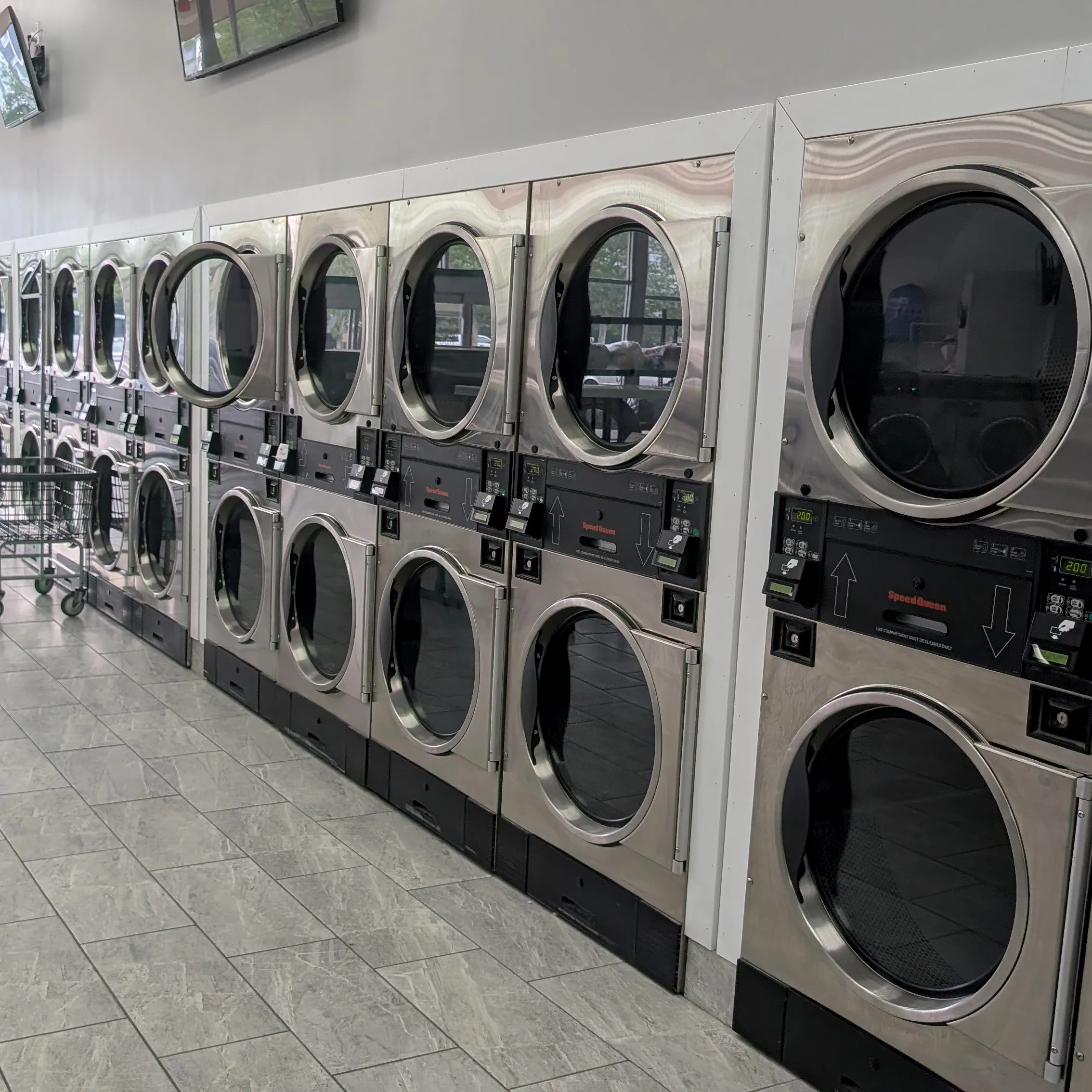 Row of stacked commercial dryers at the Detroit laundromat