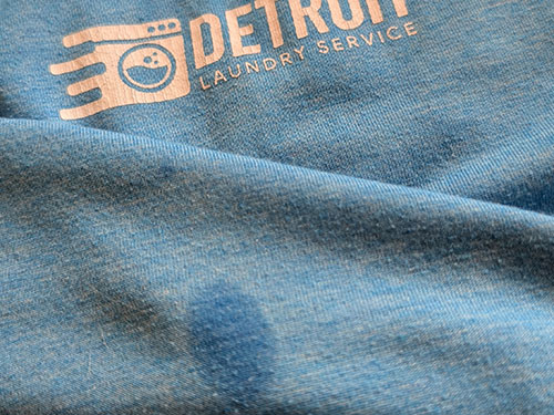 Water stain on a blue Detroit Laundry Service t-shirt