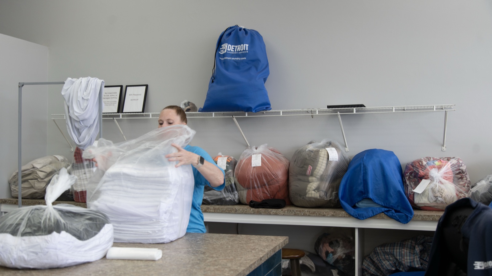 Wash and fold station with bagged orders and Detroit Laundry Service bags