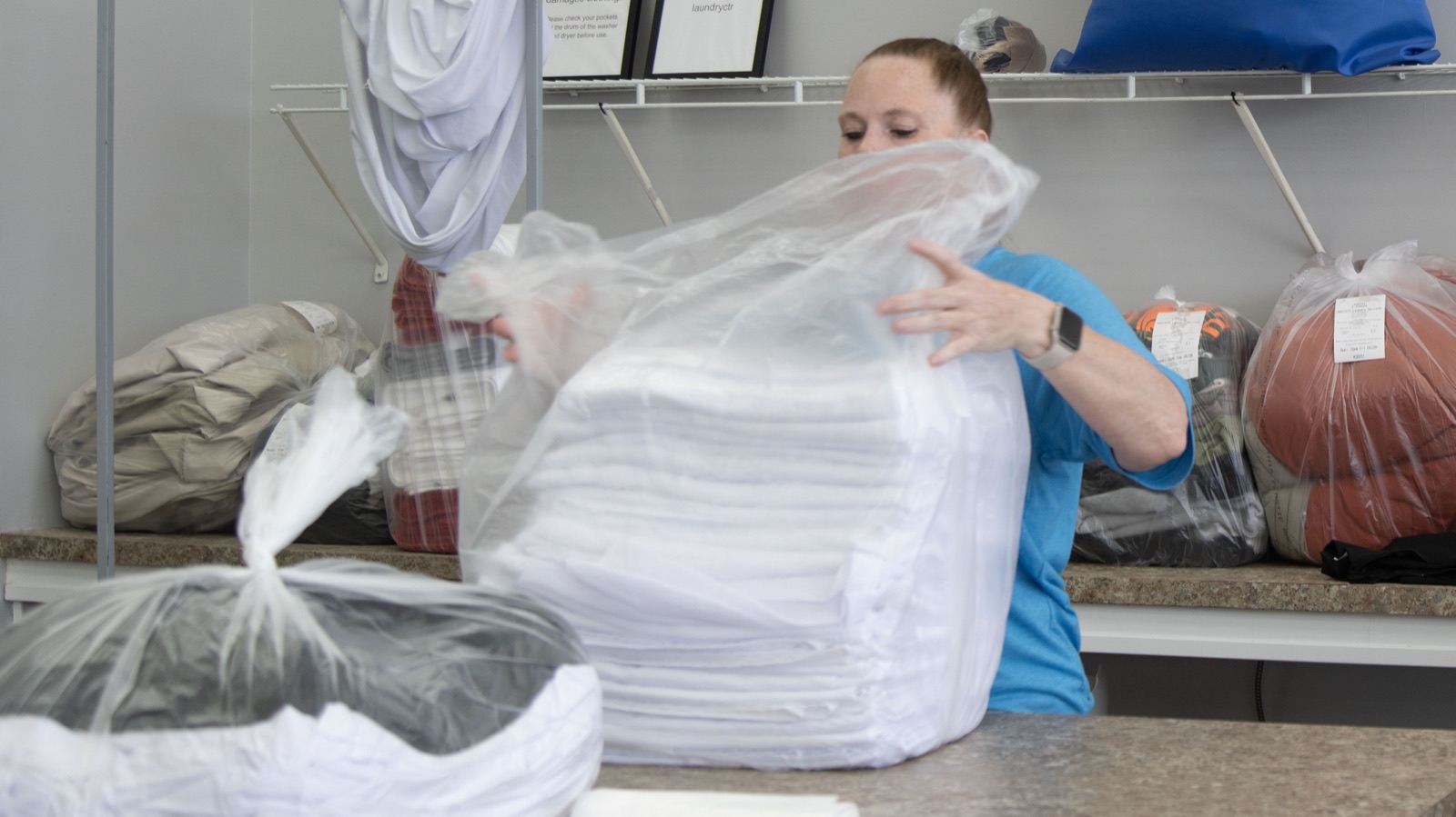 Folded laundry being packaged for next-day delivery