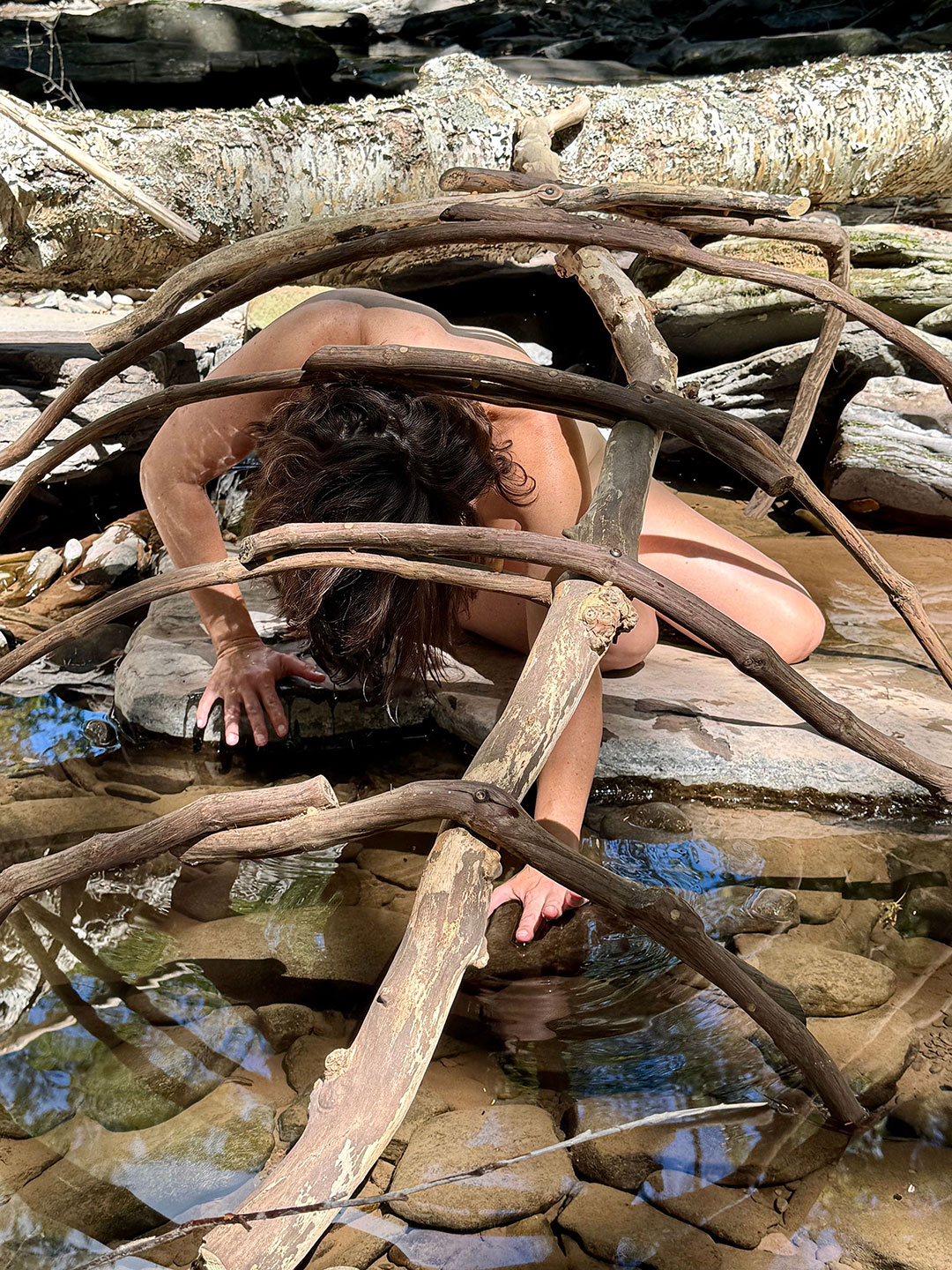 Photograph of nature-based body performance with sculpture