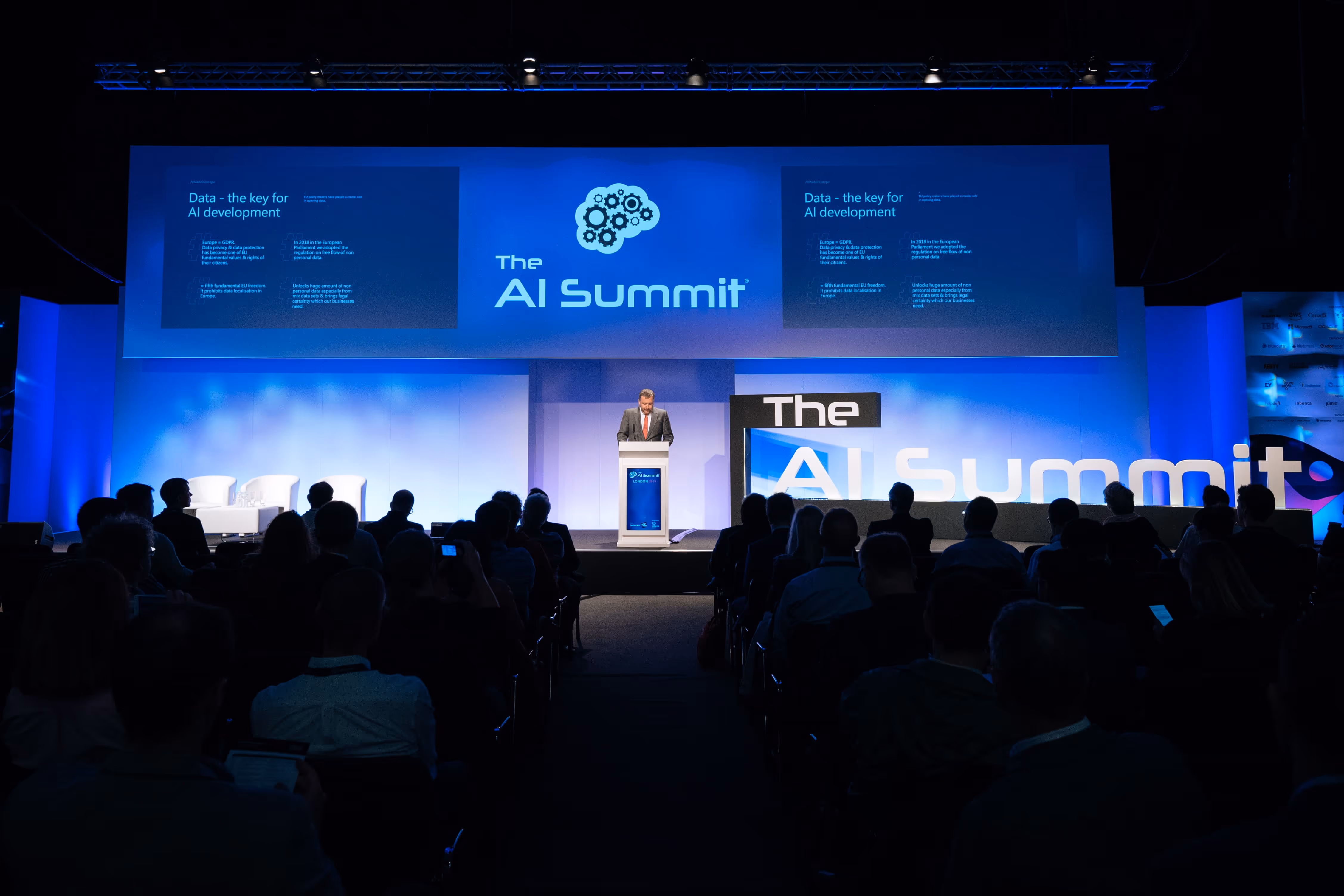 A man giving a presentation at the AI Summit.