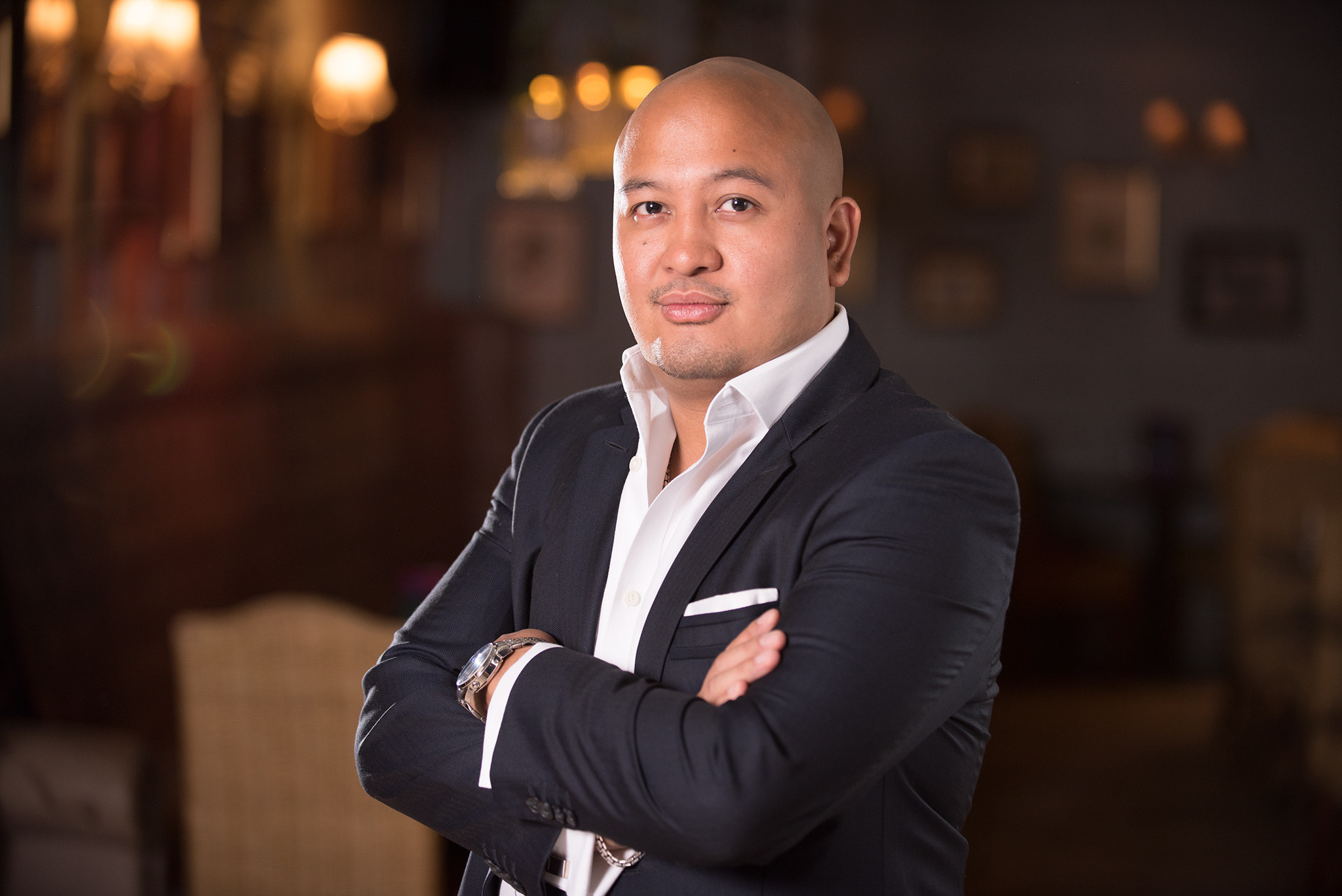 A bald man wearing a suit and tie.
