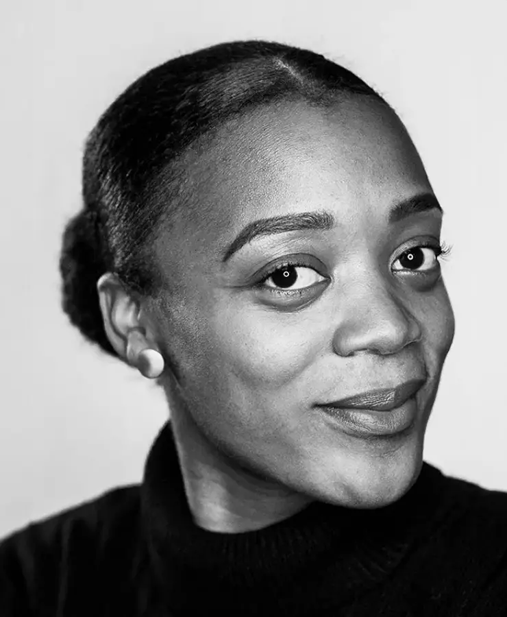 A woman with a black shirt and a smile.