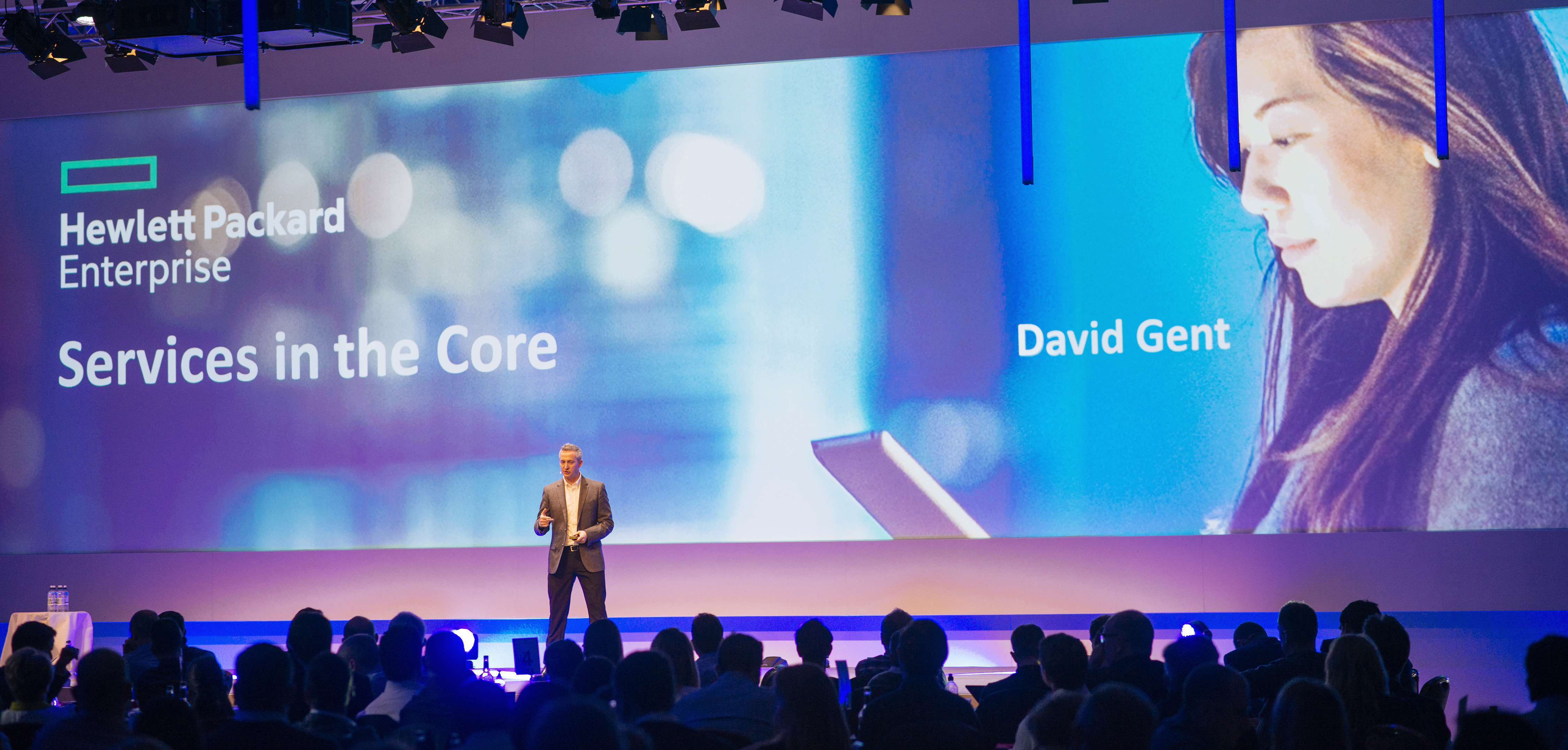 Professional conference speaker presenting on stage to engaged audience