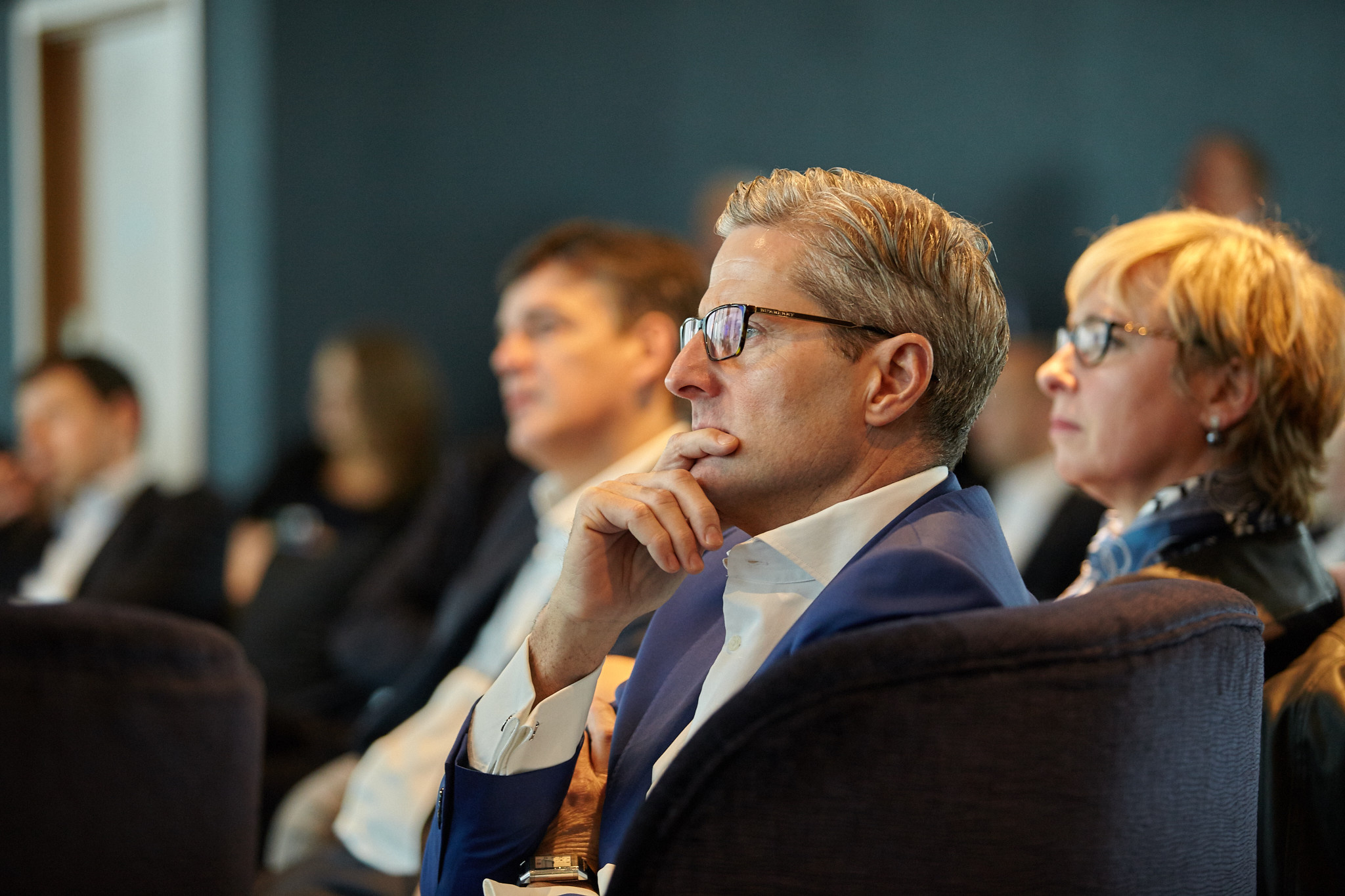 Attendees listening at a corporate conference