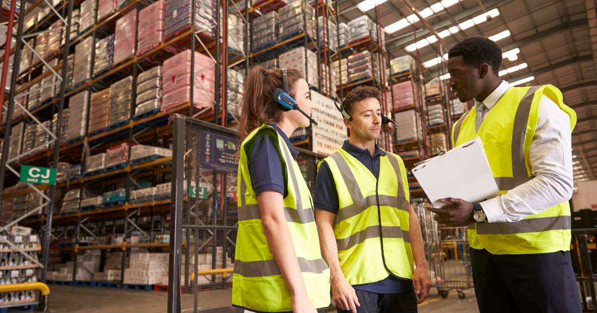 warehouse workers talking with the warehouse manager