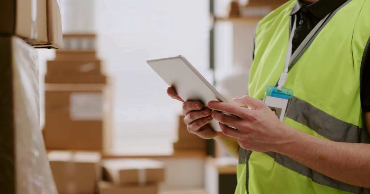 a warehouse worker using a tablet to process inbound inventory