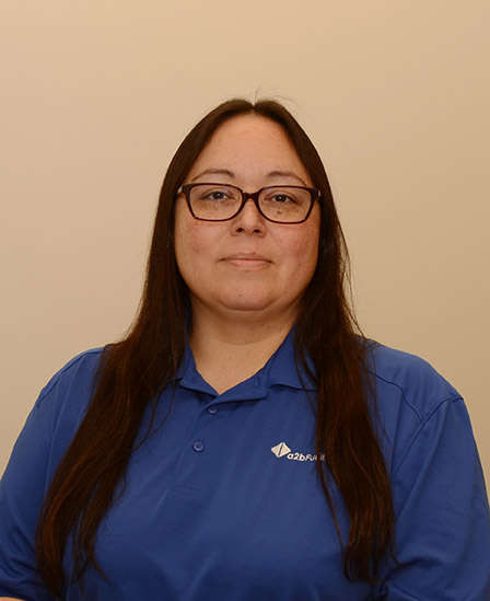 a2b Fulfillment employee wearing a blue polo with white a2b logo.