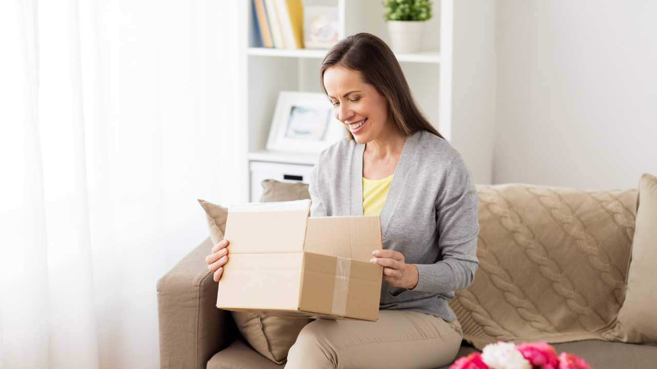 Happy customer opening a box