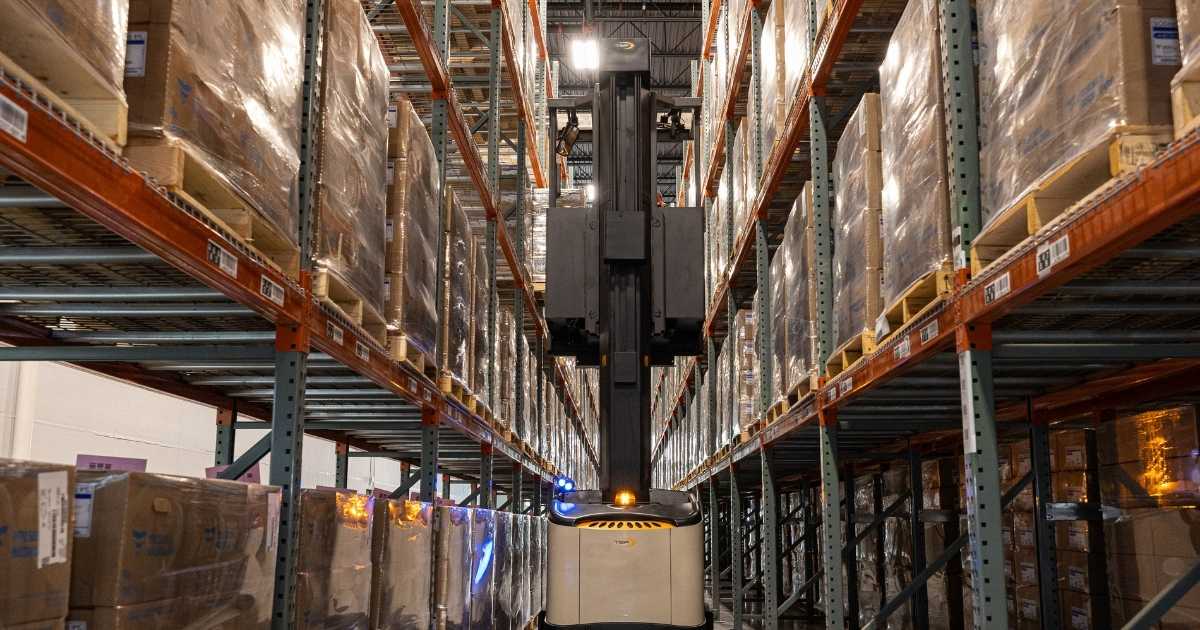 A turret forklift in a2b's Ogden facility working in a full warehouse