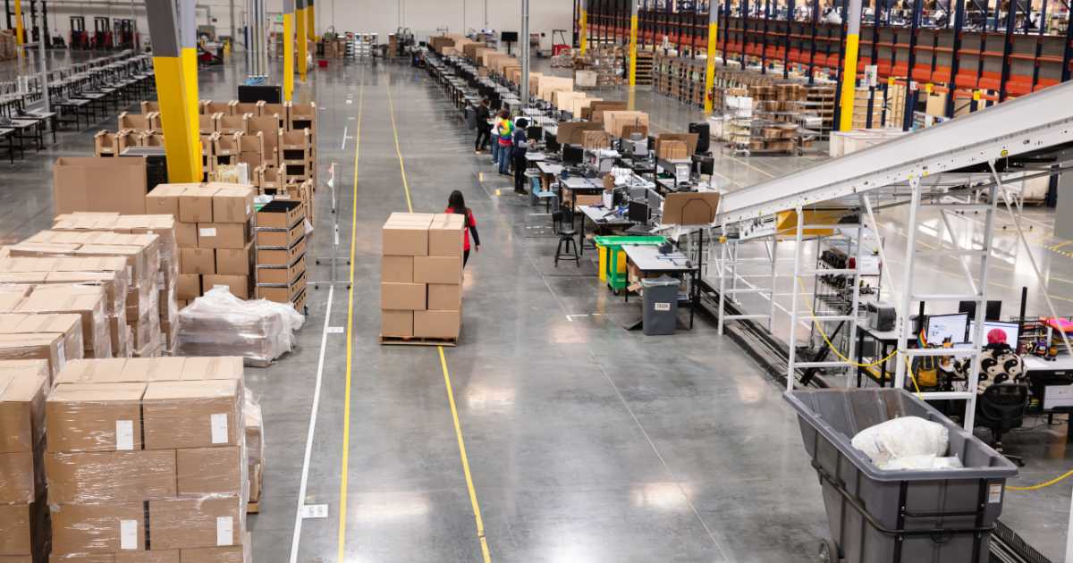 A picture of a warehouse with workers.