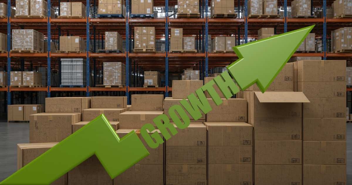 Picture of stacked boxes in a warehouse with a green arrow pointing up with growth written on it.