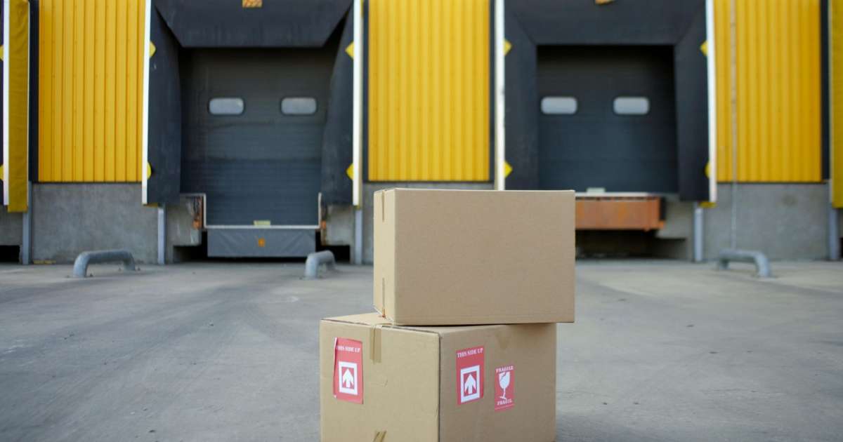 Two boxes are stacked on top of each other in front of an empty loading dock.