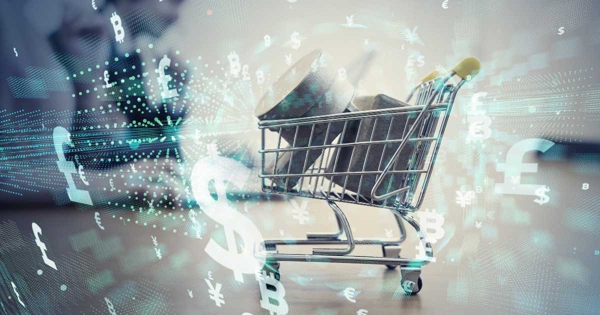 A small shopping cart with grey boxes in it, surrounded by digital images of different currencies.