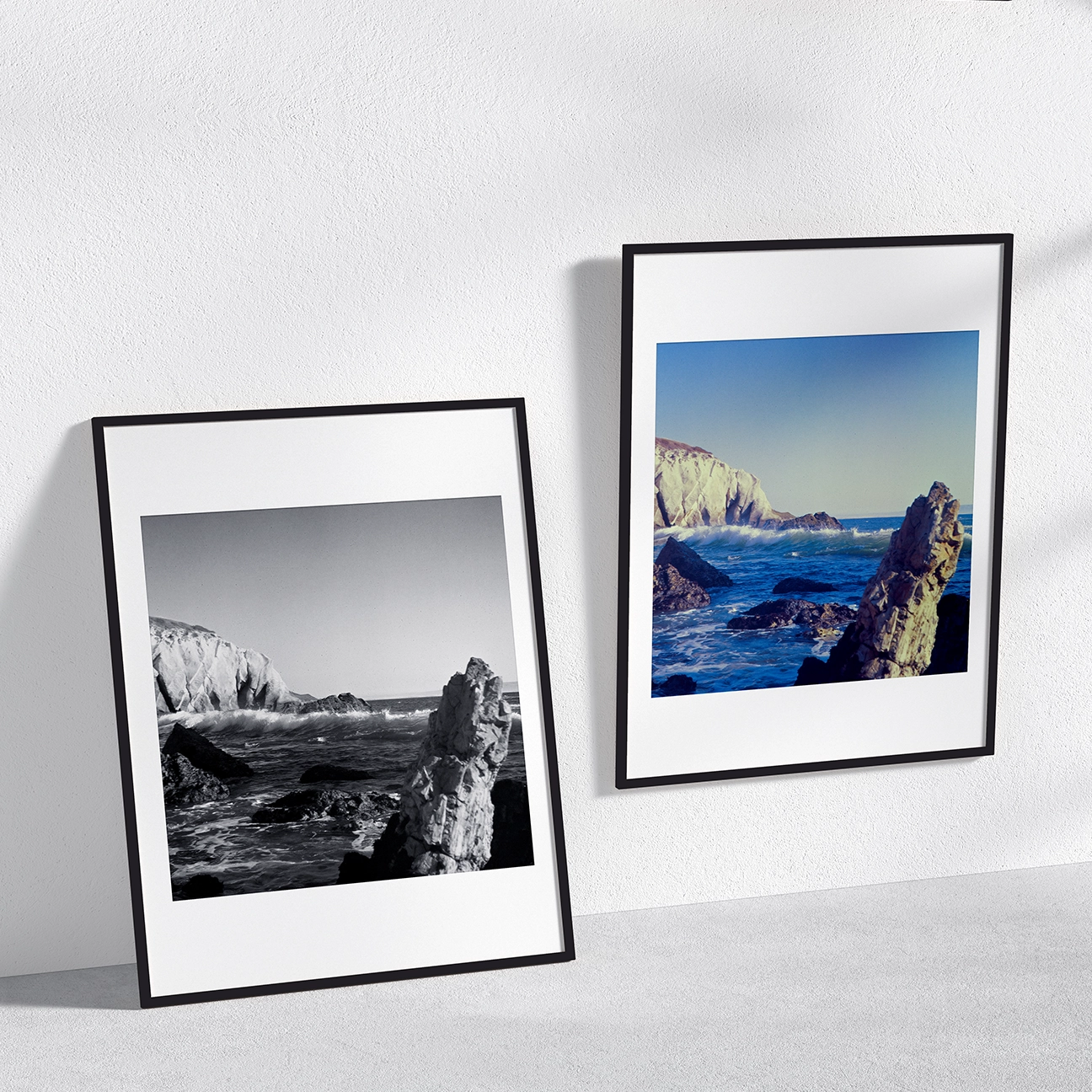 Two framed prints of a rocky coastline—one black-and-white and one color—shown side-by-side on a wall display mockup.