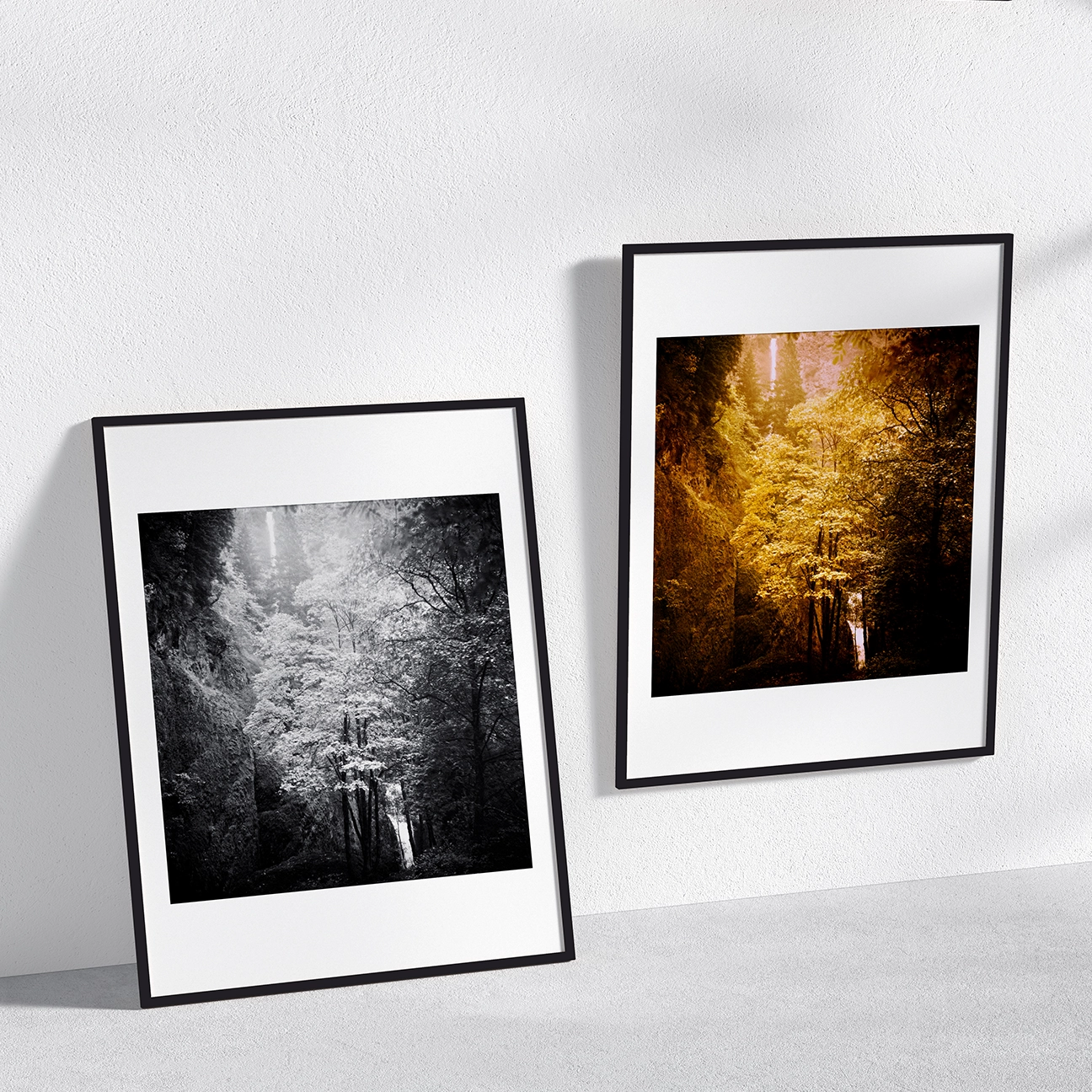 Two framed “Multnomah Falls Morning Light” prints—one B&W, one warm-toned—on a minimal wall.