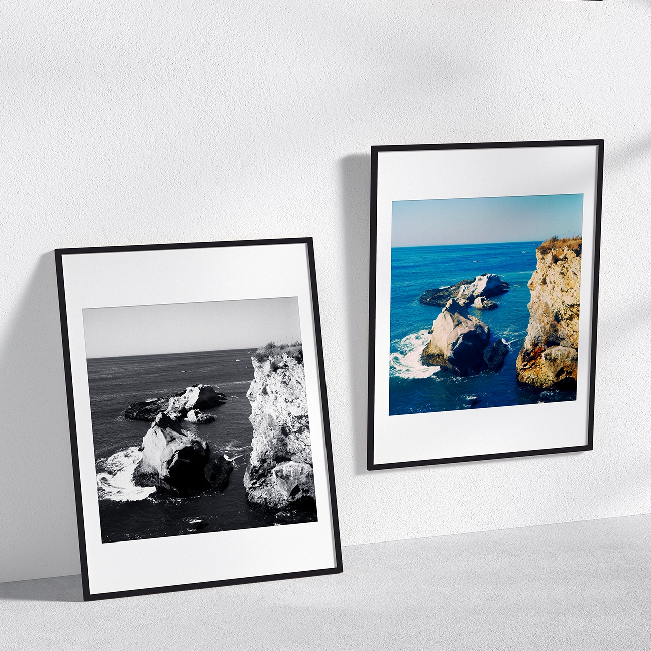 Two framed “Shell Beach” prints—black-and-white and color—showing rocky sea stacks and cliffs above the ocean.