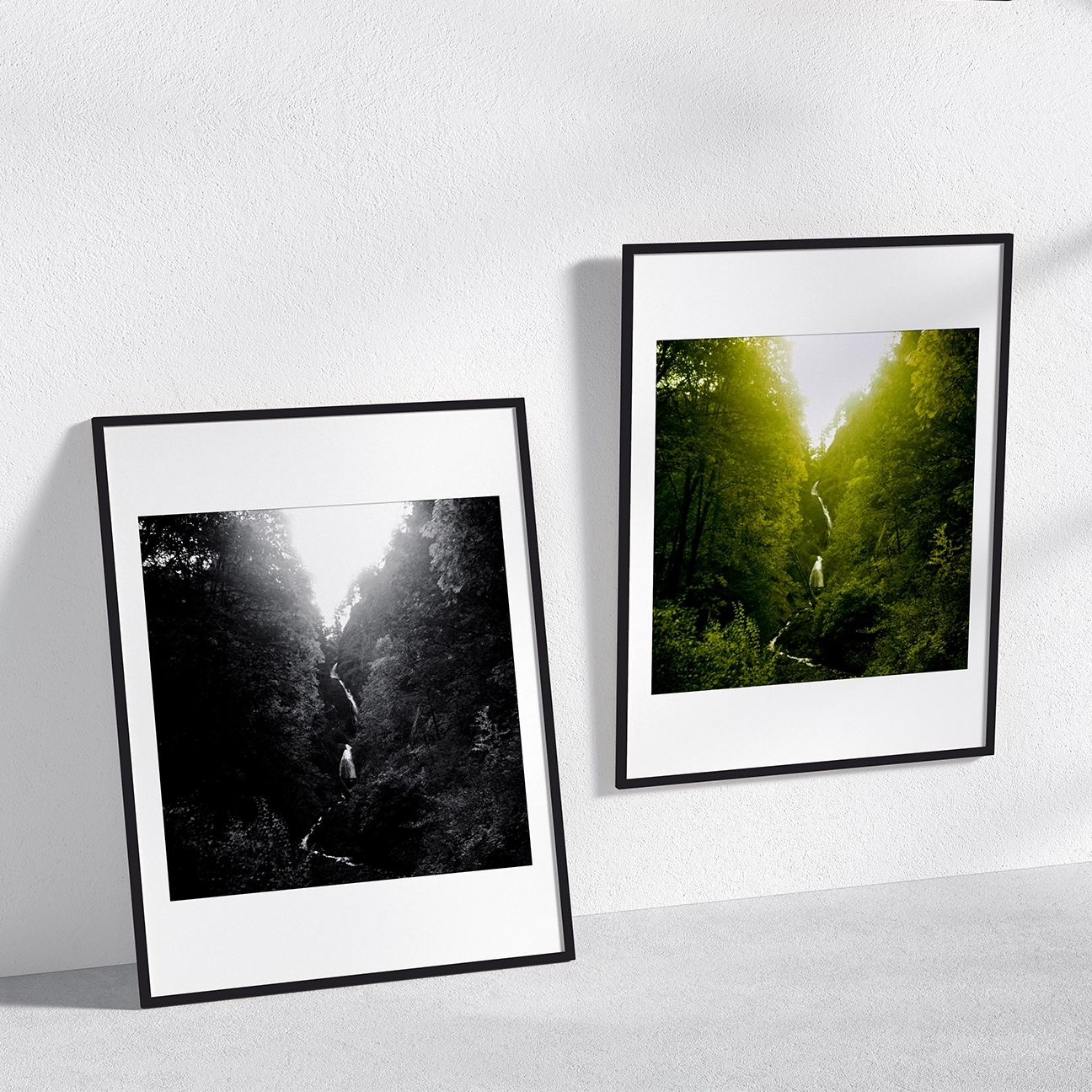 Wall mockup of “Wenatchee Falls” with two framed versions: a thin waterfall dropping through a steep, tree-filled gorge (left in black-and-white, right in vivid green).
