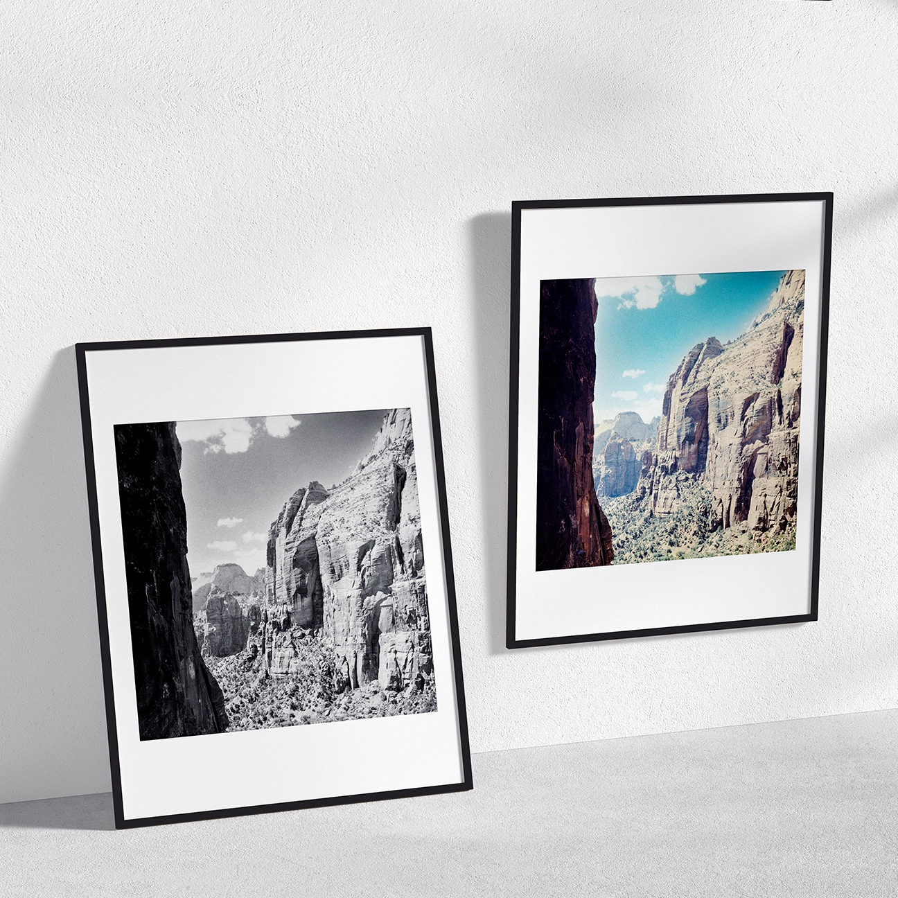 Two framed Zion landscape prints—one black-and-white, one color—on a minimalist wall.