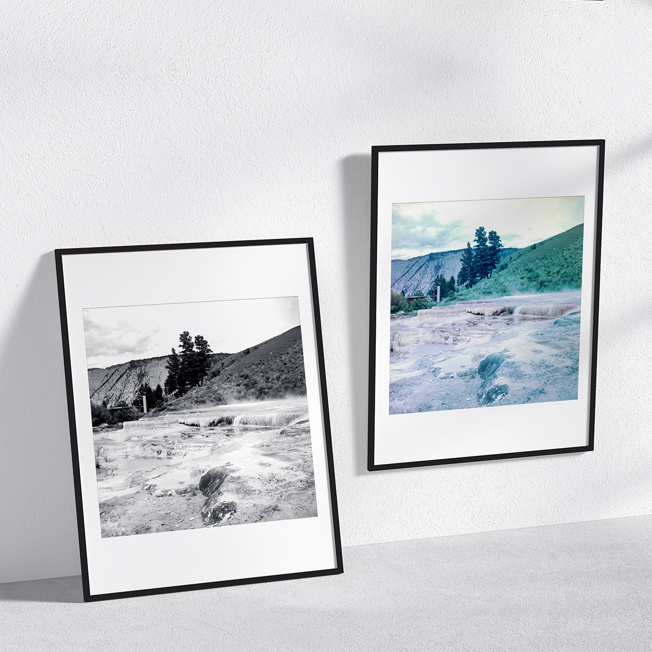 ide-by-side mockup of “Mammoth Scenic” in black-and-white and color: pale travertine terraces with a low band of steam, a few trees, and sloping hills under a cloudy sky, shown in minimalist black frames.