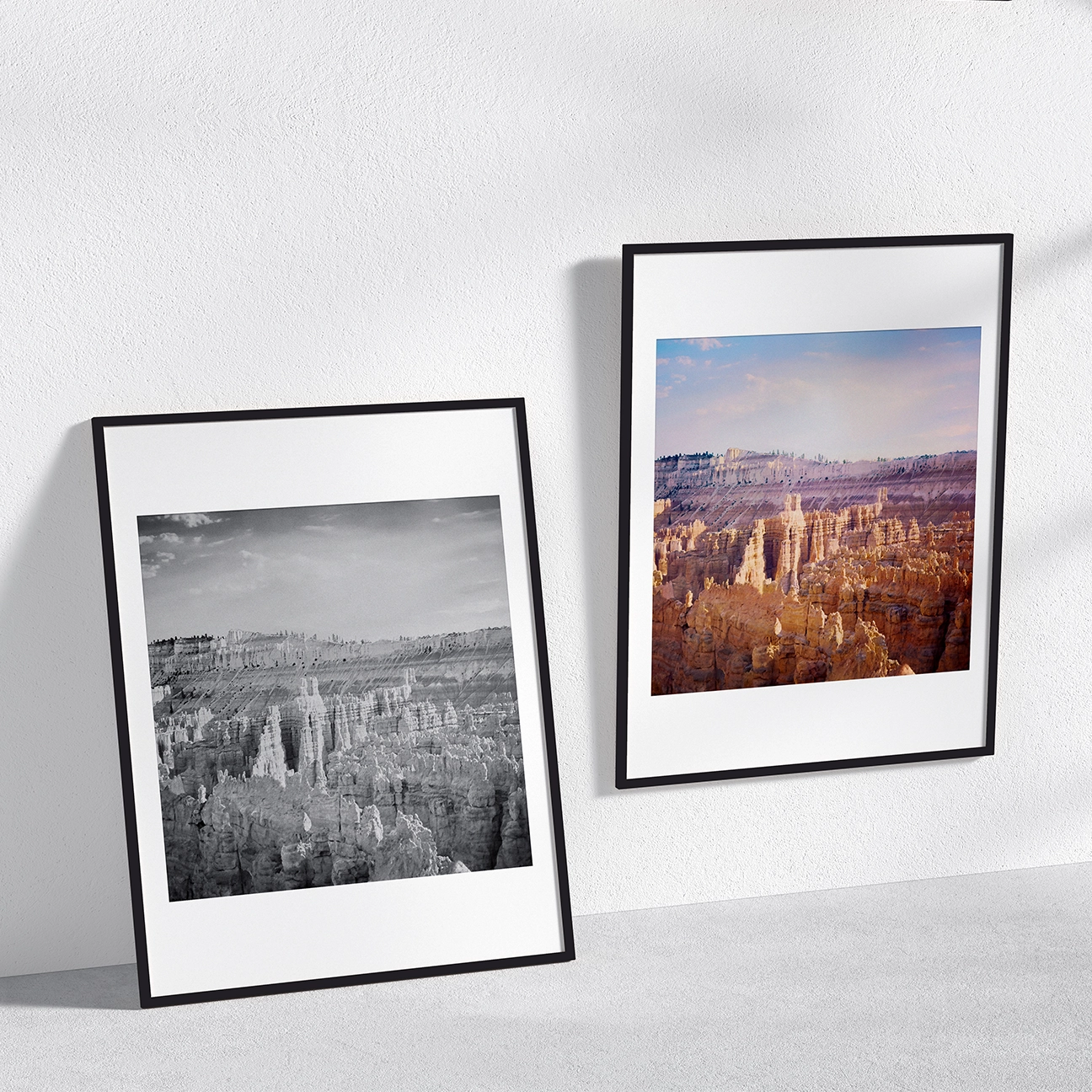 Side-by-side framed wall art featuring “Bryce Canyon Ridge”: a leaning black-and-white print and a hanging color print, both capturing Bryce Canyon’s dense hoodoo spires, textured canyon ridges, and a soft, open sky above.