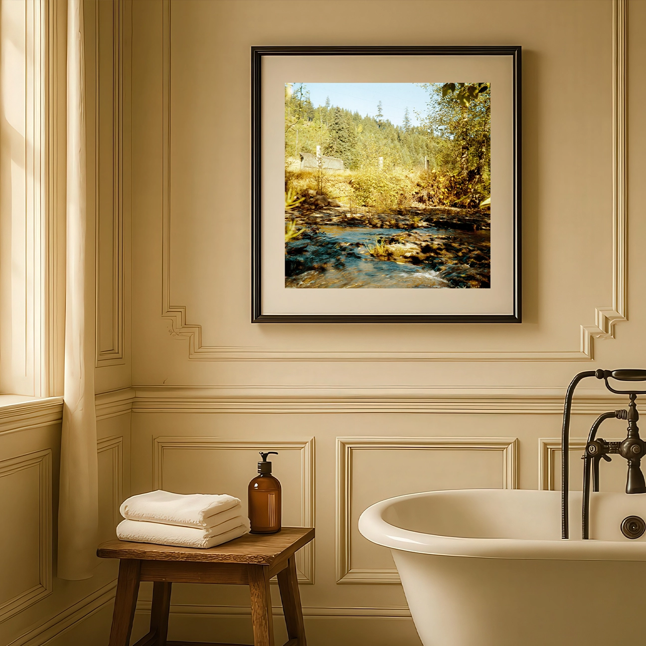 “Coal Creek” — an analog photograph capturing a golden creek flowing through lush woodland, framed elegantly in a soft beige bathroom with natural light and timeless design. The blend of warm tones brings calm and organic texture to the refined setting.