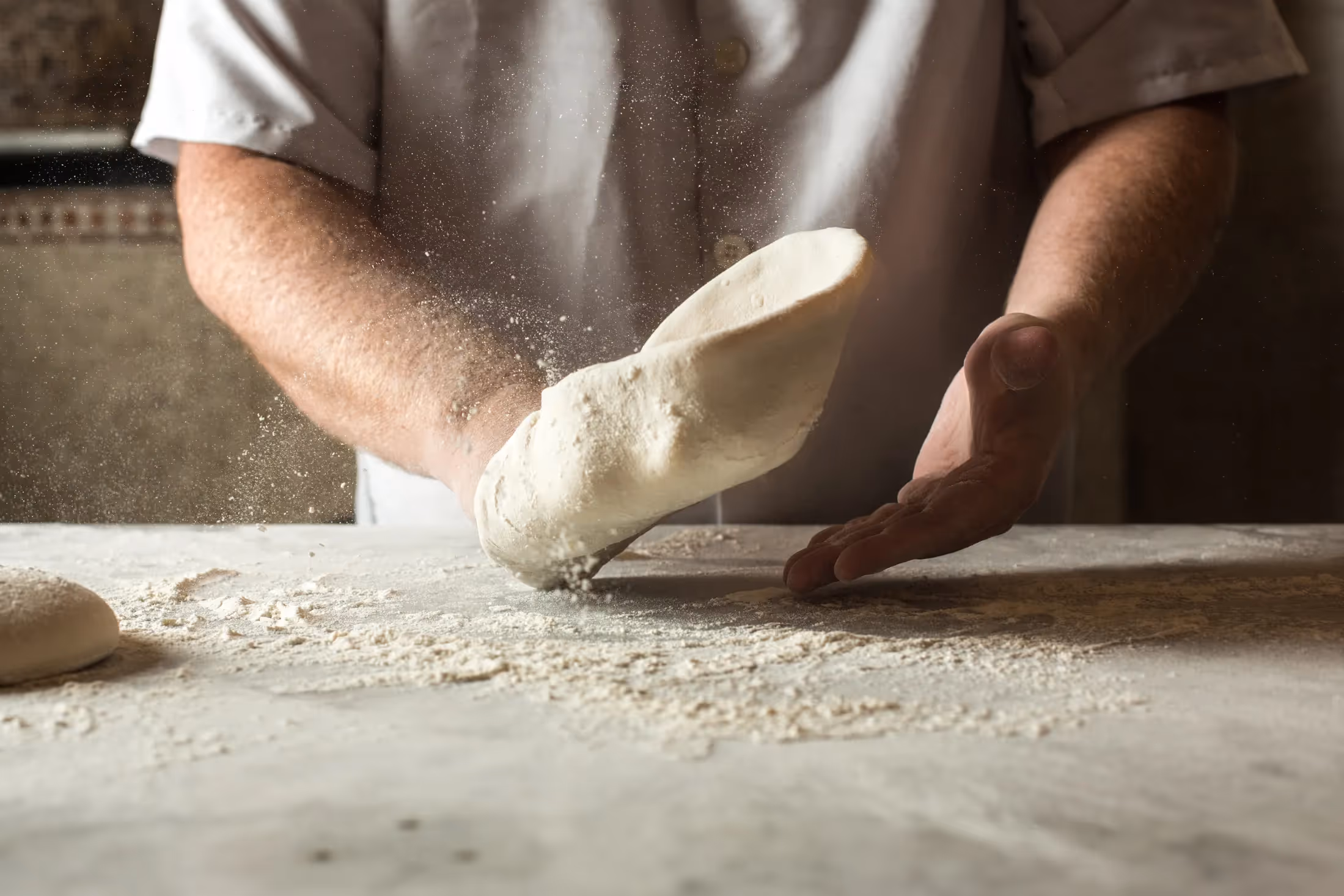 Chef at Il Pizzaiolo tossing pizza dough