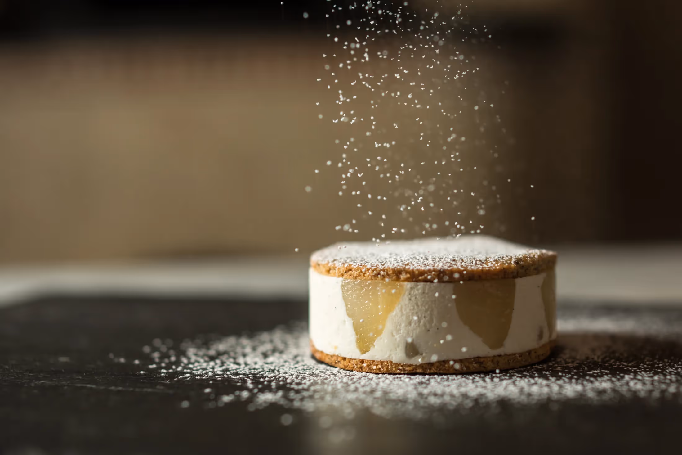 Powdered sugar being sprinkled over an Italian dessert at Il Pizzaiolo