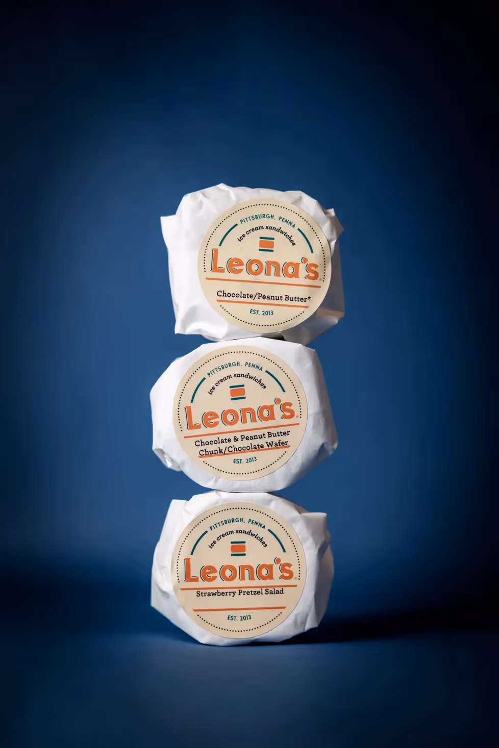 Stacked Leona's ice cream sandwiches in their packaging