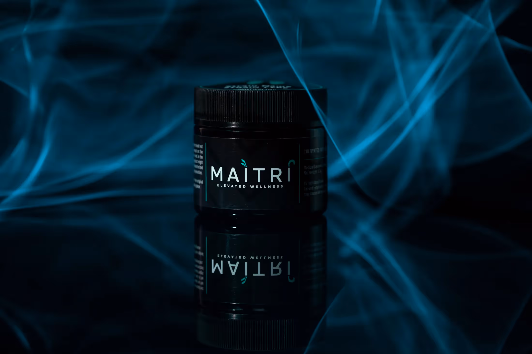 Maitri jarred product with blue smoke behind it