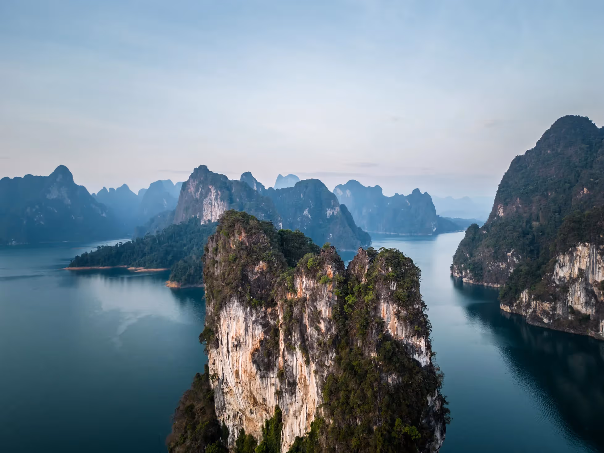 Drone shot of large mountains surrounded by water
