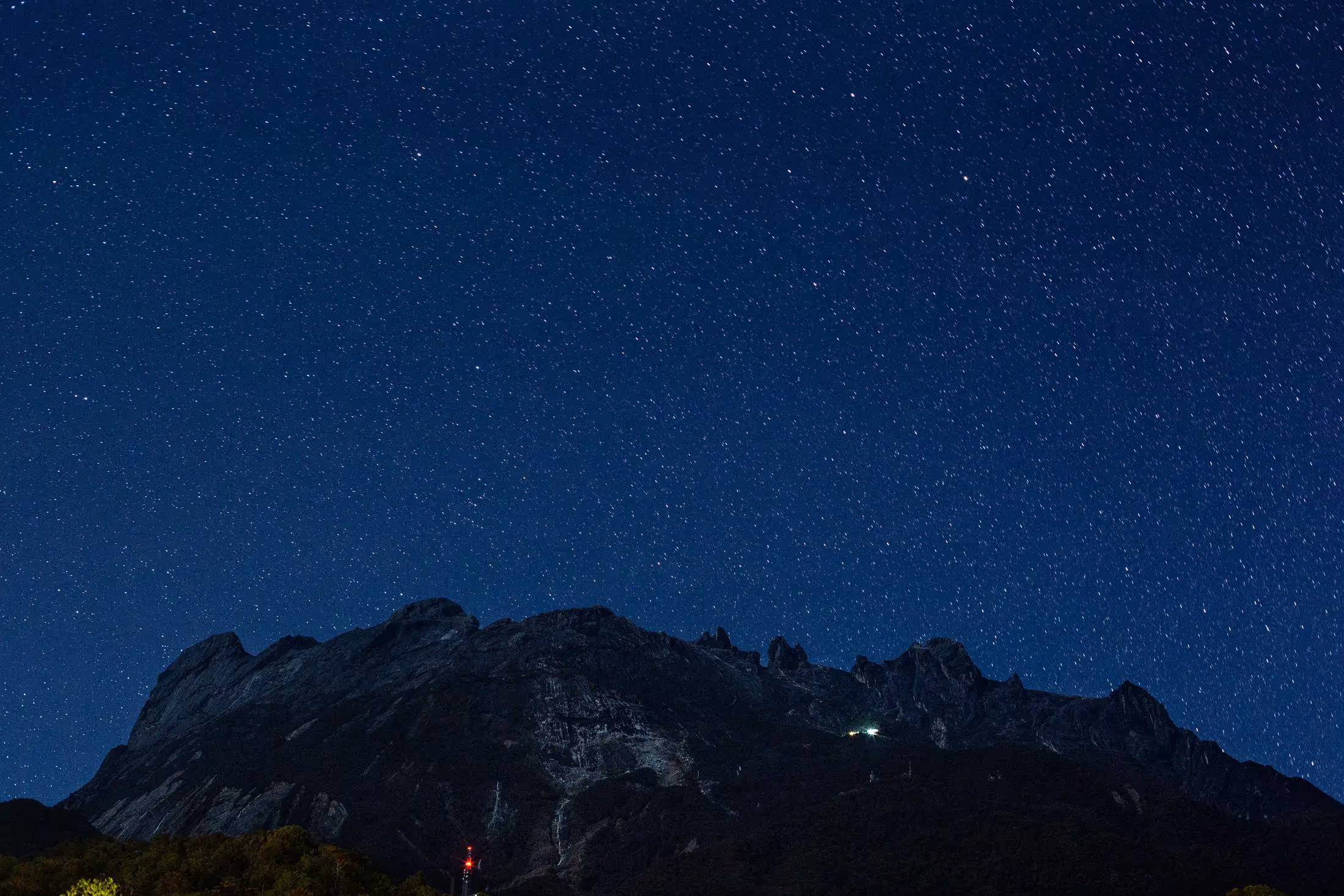 Mt Kinabalu at night against a star-filled sky