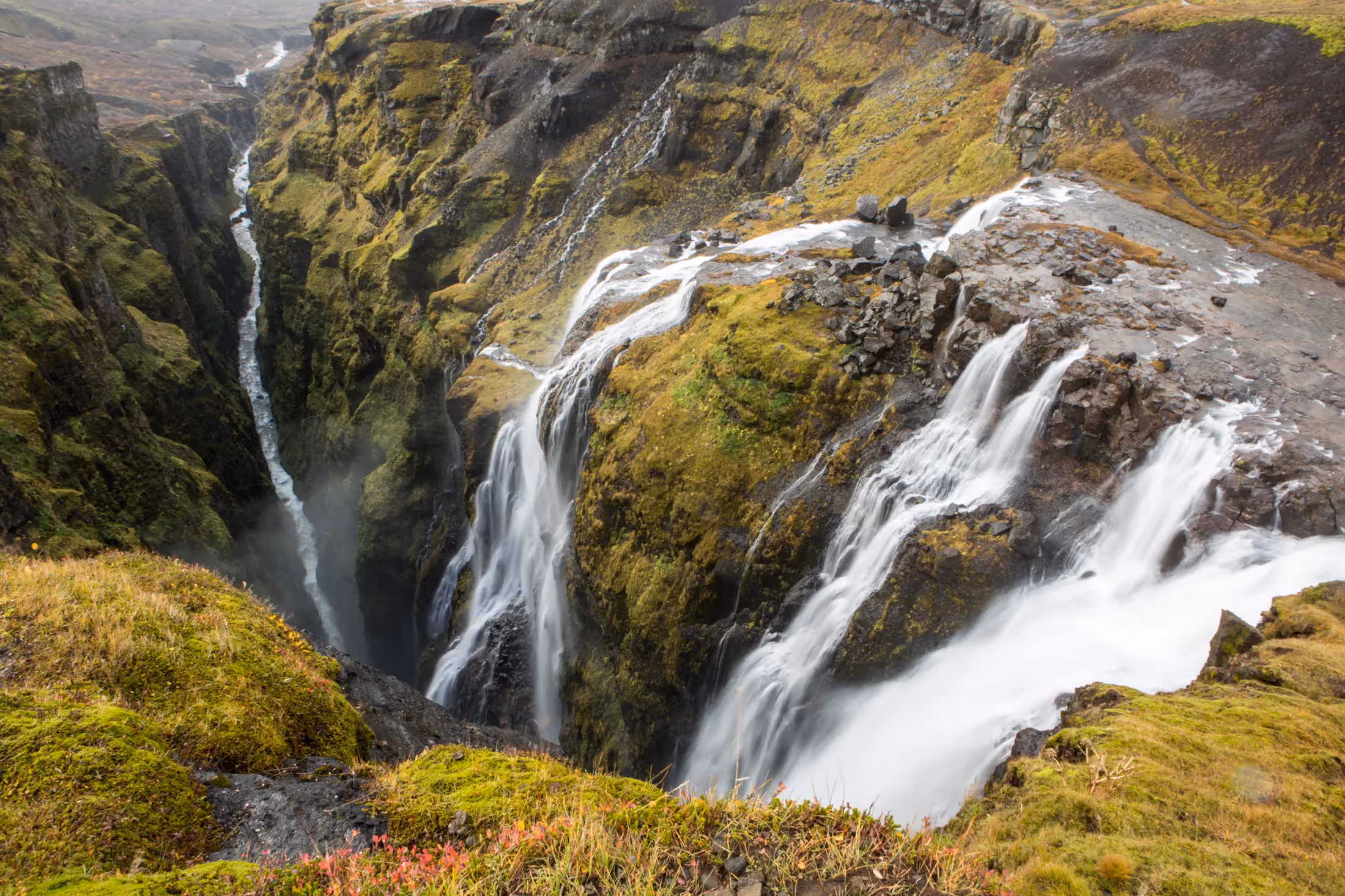 Waterfall over rocks and moss in Iceland