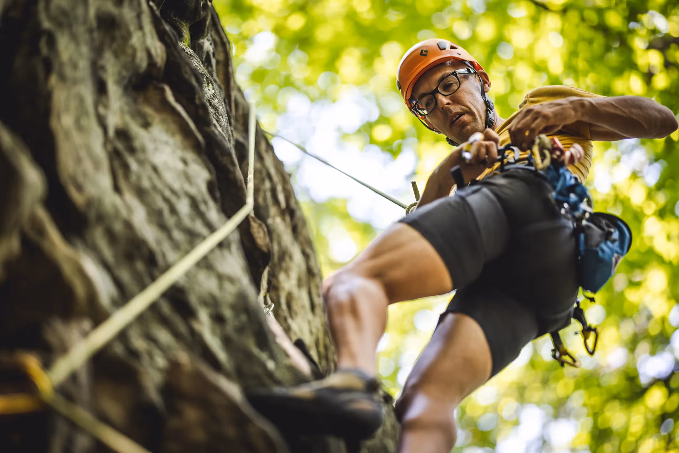 Man rock climbing and looking down
