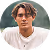 A man in a white shirt is looking at the camera.