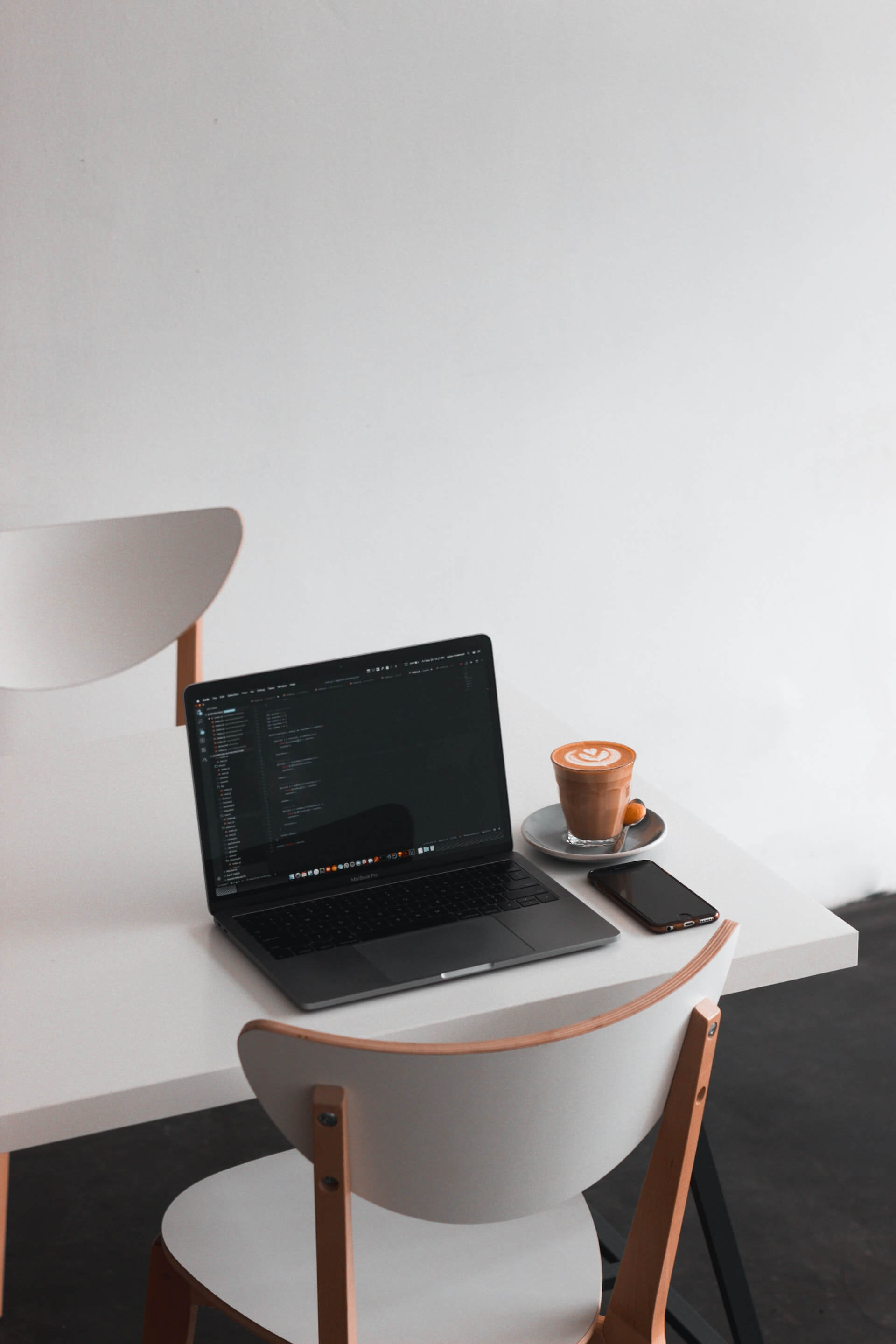 Laptop perched on a side table