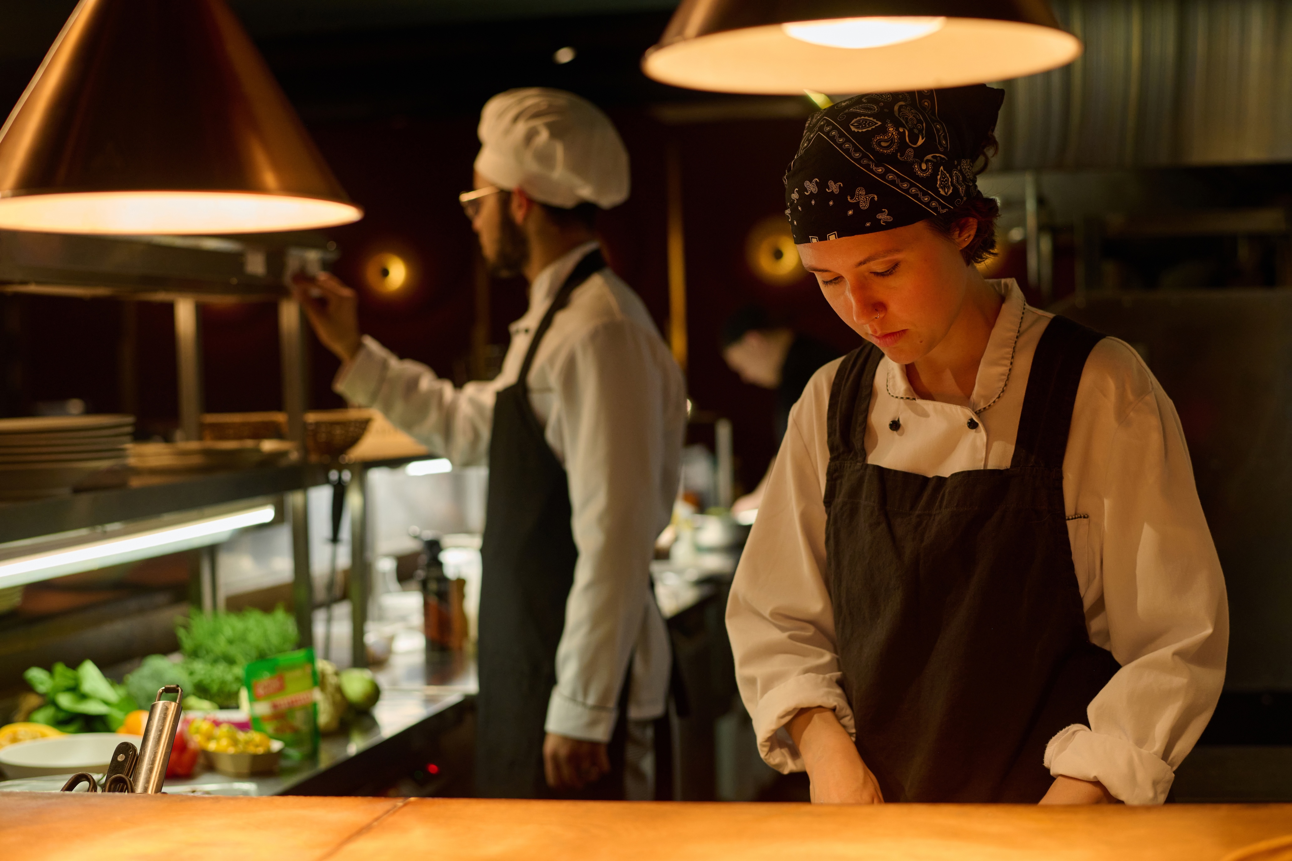 Two food employees working in the kitchen
