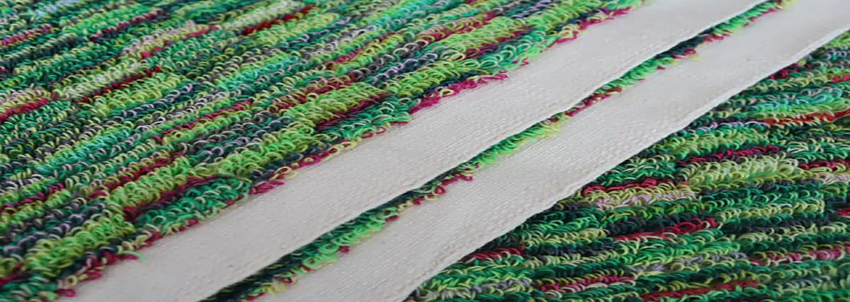 Close-up of the selvage edge on a hand-woven thick-looped Turkish towel made on a traditional shuttle loom at Jennifer's Hamam, showing the self-finished unstitched border