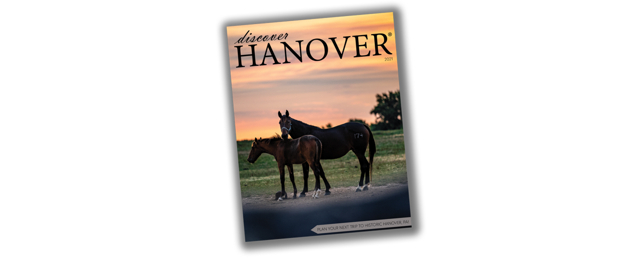 Front cover of Discover Hanover® 2021. An image of 2 horses during sunset