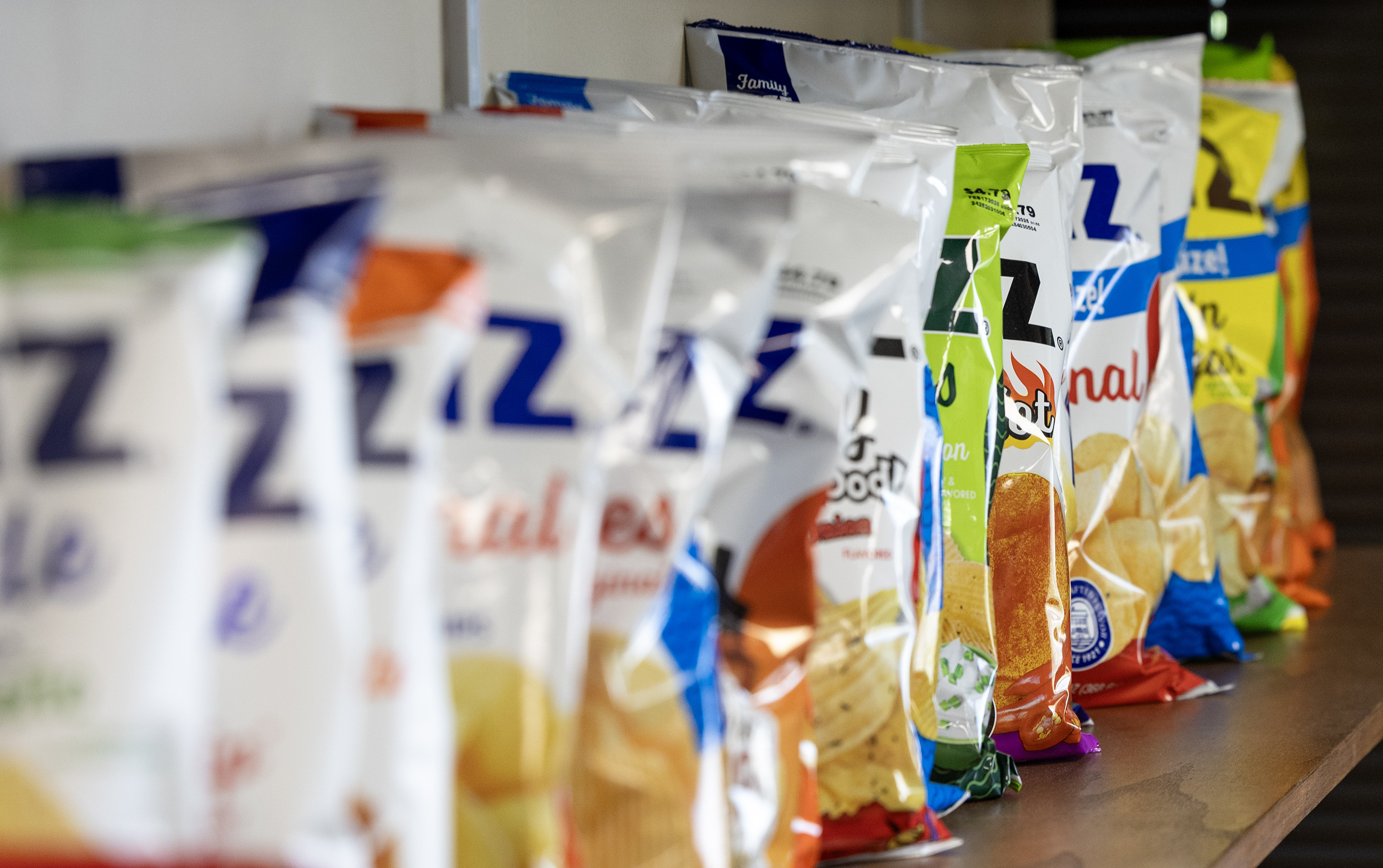 Assorted Utz chips in a row on the shelf