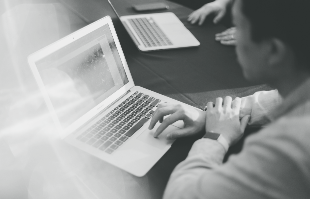 Man sitting in front of a laptop