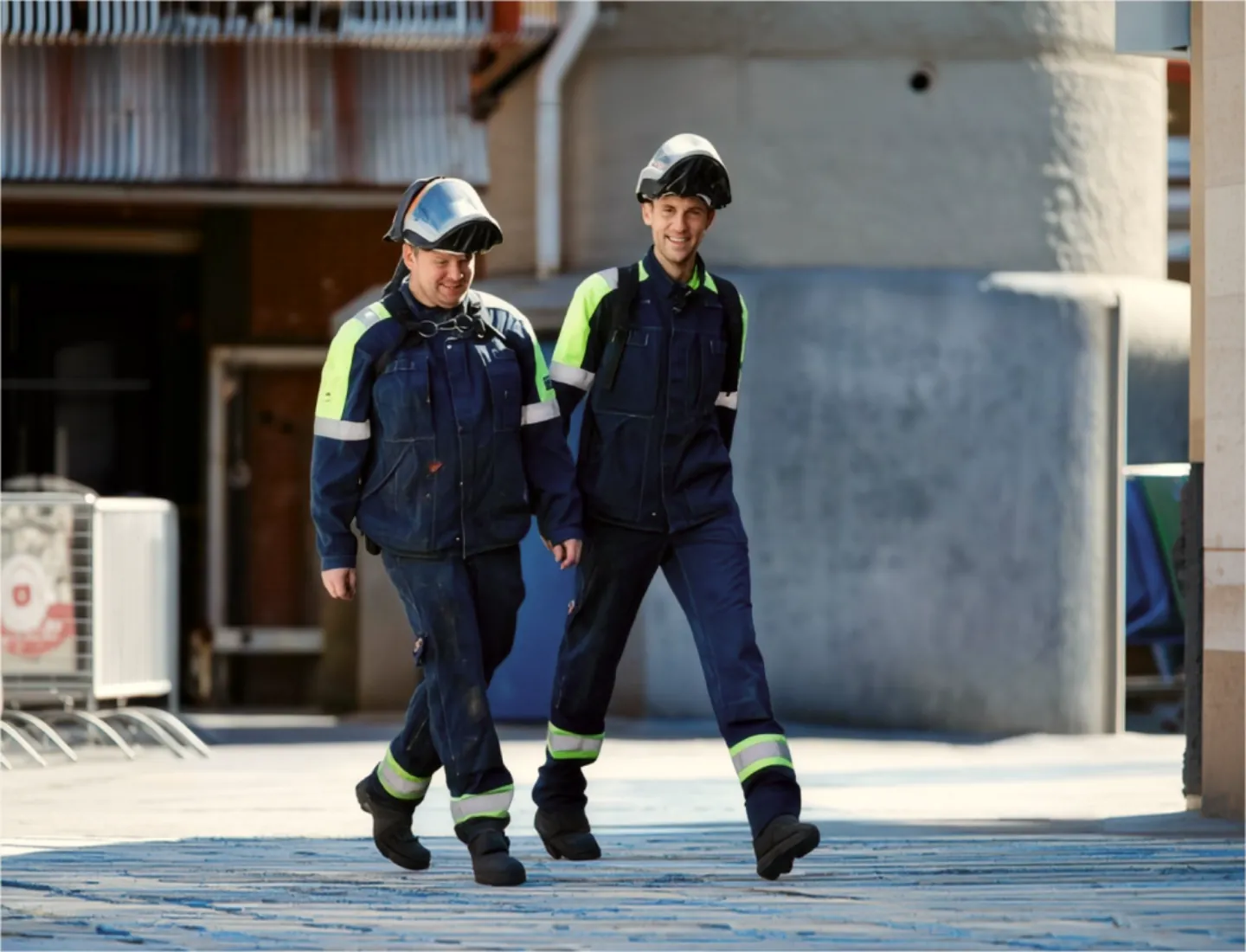Two WTR Group service technicians walking across a plant yard