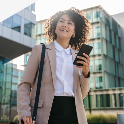 Person checking their phone outside an office building